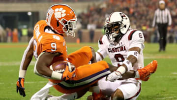 CLEMSON, SC - NOVEMBER 24: Keisean Nixon #9 of the South Carolina Gamecocks tackles Travis Etienne #9 of the Clemson Tigers during their game at Clemson Memorial Stadium on November 24, 2018 in Clemson, South Carolina. (Photo by Streeter Lecka/Getty Images)