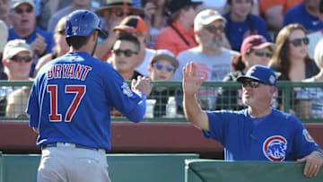 Mar 24, 2016; Scottsdale, AZ, USA; Chicago Cubs third baseman Kris Bryant (17) is greeted by manager Joe Maddon during the first inning after scoring a run against the San Francisco Giants at Scottsdale Stadium. Mandatory Credit: Joe Camporeale-USA TODAY Sports