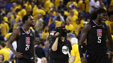OAKLAND, CALIFORNIA - APRIL 15: Patrick Beverley #21 and Montrezl Harrell #5 of the LA Clippers celebrate after they beat the Golden State Warriors during Game Two of the first round of the 2019 NBA Western Conference Playoffs at ORACLE Arena on April 15, 2019 in Oakland, California. NOTE TO USER: User expressly acknowledges and agrees that, by downloading and or using this photograph, User is consenting to the terms and conditions of the Getty Images License Agreement. (Photo by Ezra Shaw/Getty Images)