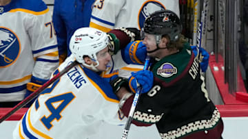 Jan 29, 2022; Glendale, Arizona, USA; Buffalo Sabres center Dylan Cozens (24) and Arizona Coyotes defenseman Jakob Chychrun (6) shove each other in the third period at Gila River Arena. Mandatory Credit: Rick Scuteri-USA TODAY Sports