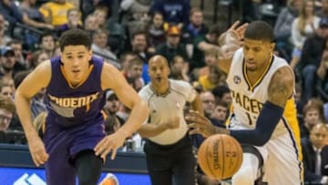 Jan 12, 2016; Indianapolis, IN, USA; Phoenix Suns guard Devin Booker (1) and Indiana Pacers forward Paul George (13) fight for a loose ball in the second half of the game at Bankers Life Fieldhouse. The Indiana Pacers beat the Phoenix Suns by the score of 116-97. Mandatory Credit: Trevor Ruszkowski-USA TODAY Sports