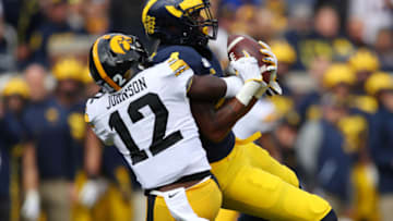 ANN ARBOR, MICHIGAN - OCTOBER 05: Nico Collins #4 of the Michigan Wolverines makes a first quarter catch against D.J. Johnson #12 of the Iowa Hawkeyes at Michigan Stadium on October 05, 2019 in Ann Arbor, Michigan. (Photo by Gregory Shamus/Getty Images)