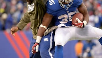 Nov 10, 2013; East Rutherford, NJ, USA; New York Giants running back Andre Brown (35) celebrates a touchdown with New York Giants running back Brandon Jacobs (34) (not playing) during the third quarter agains the the Oakland Raiders at MetLife Stadium. Mandatory Credit: Robert Deutsch-USA TODAY Sports