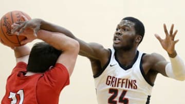 Buchtel's Chris Livingston, facing, attempts to knock the ball from the hands of Firelands' Casey Kelley during the first half of a Division II district semifinal basketball game, Thursday, March 4, 2021, in Akron, Ohio. [Jeff Lange/Beacon Journal]Buchtelmbb 2