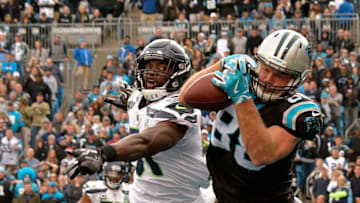 CHARLOTTE, NC - NOVEMBER 25: Barkevious Mingo #51 of the Seattle Seahawks breaks up a pass in the end zone intended for Greg Olsen #88 of the Carolina Panthers during the second half of their game at Bank of America Stadium on November 25, 2018 in Charlotte, North Carolina. (Photo by Grant Halverson/Getty Images)