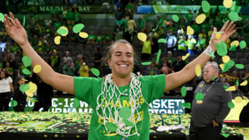 LAS VEGAS, NEVADA - MARCH 08: Sabrina Ionescu #20 of the Oregon Ducks wears a basketball net around her neck and throws confetti in the air as she celebrates her team's 89-56 win over the Stanford Cardinal to win the championship game of the Pac-12 Conference women's basketball tournament at the Mandalay Bay Events Center on March 8, 2020 in Las Vegas, Nevada. (Photo by Ethan Miller/Getty Images)