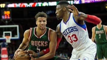 Apr 13, 2015; Philadelphia, PA, USA; Milwaukee Bucks guard Michael Carter-Williams (5) protects the ball as he drives past Philadelphia 76ers forward Robert Covington (33) during the first quarter at Wells Fargo Center. Mandatory Credit: Bill Streicher-USA TODAY Sports