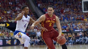 Mar 14, 2015; Kansas City, MO, USA; Iowa State Cyclones forward Abdel Nader (2) dribbles the ball as Kansas Jayhawks guard Devonte Graham (4) defends during the championship game of the Big 12 tournament at Sprint Center. Mandatory Credit: Denny Medley-USA TODAY Sports