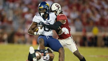 Oklahoma's David Ugwoegbu (2) and Pat Fields (10) bring down West Virginia's Bryce Ford-Wheaton (0) during a college football game between the University of Oklahoma Sooners (OU) and the West Virginia Mountaineers at Gaylord Family-Oklahoma Memorial Stadium in Norman, Okla., Saturday, Sept. 25, 2021. Oklahoma won 16-13.Lx11186