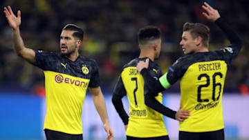 DORTMUND, GERMANY - FEBRUARY 18: Emre Can, Jadon Sancho and Lukas Piszczek (L-R) of Dortmund react during the UEFA Champions League round of 16 first leg match between Borussia Dortmund and Paris Saint-Germain at Signal Iduna Park on February 18, 2020 in Dortmund, Germany. (Photo by Alex Grimm/Getty Images)