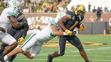 Auburn football Oct 9, 2021; Columbia, Missouri, USA; Missouri Tigers running back Tyler Badie (1) runs the ball and is tackled by North Texas Mean Green linebacker Larry Nixon III (30) during the game at Faurot Field at Memorial Stadium. Mandatory Credit: Denny Medley-USA TODAY Sports