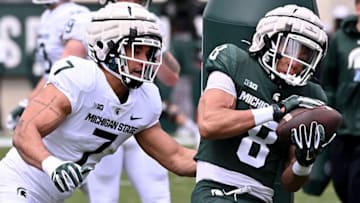 Apr 16, 2022; East Lansing, Michigan, USA; Michigan State University Spartans running back Jalen Berger (8) takes a pass in front of Michigan State University Spartans linebacker Aaron Brule (7) at Spartan Stadium. Mandatory Credit: Dale Young-USA TODAY Sports