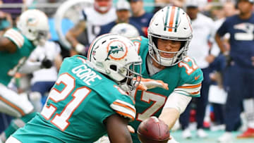 MIAMI, FL - DECEMBER 09: Ryan Tannehill #17 hands the ball off to Frank Gore #21 of the Miami Dolphins in the second half against the New England Patriots at Hard Rock Stadium on December 9, 2018 in Miami, Florida. (Photo by Mark Brown/Getty Images)
