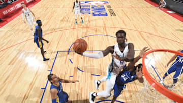 LAS VEGAS, NV - JULY 11: Mangok Mathiang #9 of the Charlotte Hornets goes to the basket against the Golden State Warriors during the 2018 Las Vegas Summer League on July 11, 2018 at the Thomas & Mack Center in Las Vegas, Nevada. NOTE TO USER: User expressly acknowledges and agrees that, by downloading and/or using this Photograph, user is consenting to the terms and conditions of the Getty Images License Agreement. Mandatory Copyright Notice: Copyright 2018 NBAE (Photo by Garrett Ellwood/NBAE via Getty Images)