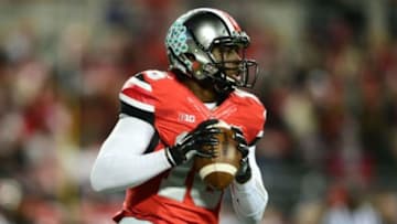 Nov 1, 2014; Columbus, OH, USA; Ohio State Buckeyes quarterback J.T. Barrett (16) rolls out of the pocket to pass during the first quarter against the Illinois Fighting Illini at Ohio Stadium. Mandatory Credit: Andrew Weber-USA TODAY Sports