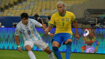 Argentina's Marcos Acuna (L) and Brazil's Richarlison vie for the ball during the Conmebol 2021 Copa America football tournament final match at Maracana Stadium in Rio de Janeiro, Brazil, on July 10, 2021. (Photo by NELSON ALMEIDA / AFP) (Photo by NELSON ALMEIDA/AFP via Getty Images)