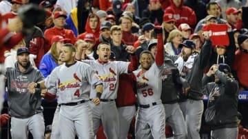 Oct 12, 2012; Washington, DC, USA; Members of the St. Louis Cardinals including Yadier Molina (4) celebrate in the dugout as two runs score against the Washington Nationals during the ninth inning of game five of the 2012 NLDS at Nationals Park. Mandatory Credit: Brad Mills-USA TODAY Sports