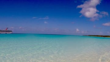 A Carnival Cruise ship is docked off Half Moon Cay in the Bahamas.