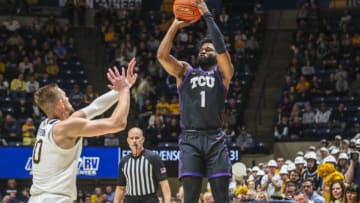 Jan 18, 2023; Morgantown, West Virginia, USA; TCU Horned Frogs guard Mike Miles Jr. (1) shoots a three pointer over West Virginia Mountaineers guard Erik Stevenson (10) during the first half at WVU Coliseum. Mandatory Credit: Ben Queen-USA TODAY Sports