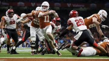 Sam Ehlinger #11 of the Texas Longhorns rushes for a touchdown which was called back by a penalty in the fourth quarter against the Utah Utes during the Valero Alamo Bowl at the Alamodome on December 31, 2019 in San Antonio, Texas. (Photo by Tim Warner/Getty Images)