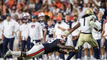 Auburn football defensive lineman T.D. Moultry (99) dives at Akron Zips quarterback Kato Nelson (1) at Jordan-Hare Stadium in Auburn, Ala., on Saturday, Sept. 4, 2021. Auburn Tigers leads Akron Zips 37-0.