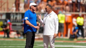 Kansas Jayhawks head coach Lance Leipold, left, talks to Texas Longhorns head coach Steve Sarkisian before their game at Royal-Memorial Stadium on Saturday September 30, 2023.