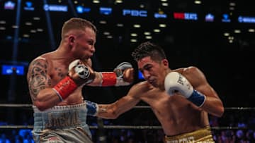 NEW YORK, NY - JULY 30: Leo Santa Cruz of Mexico (gold trunks) fights Carl Frampton of Northern Ireland (blue trunks) during their 12 round WBA Super featherweight championship bout at Barclays Center on July 30, 2016 in the Brooklyn borough in New York City. (Photo by Anthony Geathers/Getty Images)