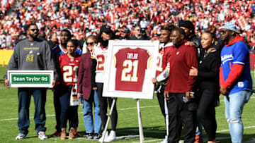 LANDOVER, MARYLAND - OCTOBER 17: Family and friends of Sean Taylor stand during the retirement ceremony of Taylor's jersey at FedExField on October 17, 2021 in Landover, Maryland. (Photo by Mitchell Layton/Getty Images)