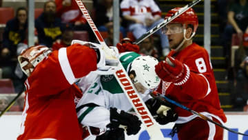 Nov 29, 2016; Detroit, MI, USA; Detroit Red Wings goalie Petr Mrazek (34) his Dallas Stars left wing Antoine Roussel (21) in front of Detroit left wing Justin Abdelkader (8) in the third period at Joe Louis Arena. Detroit won 3-1. Mandatory Credit: Rick Osentoski-USA TODAY Sports