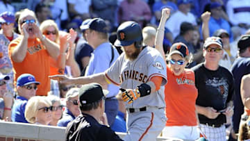Sep 2, 2016; Chicago, IL, USA; San Francisco Giants right fielder Hunter Pence (center) is greeted by manager Bruce Bochy (15) after hitting a home run against the Chicago Cubs during the seventh inning at Wrigley Field. Mandatory Credit: David Banks-USA TODAY Sports