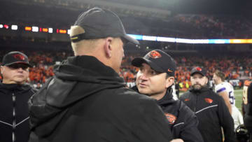Nov 18, 2023; Corvallis, Oregon, USA; Washington Huskies head Coach Kalen DeBoer (left) and Oregon State Beavers head coach Jonathan Smith meet after a game at Reser Stadium. Mandatory Credit: Soobum Im-USA TODAY Sports