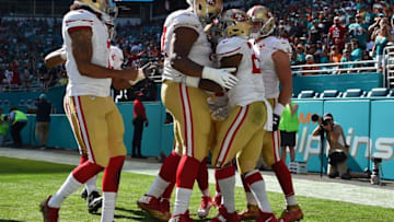 Nov 27, 2016; Miami Gardens, FL, USA; San Francisco 49ers running back Carlos Hyde (28) celebrates with teammates after scoring a touchdown against the Miami Dolphins during the first half at Hard Rock Stadium. Mandatory Credit: Jasen Vinlove-USA TODAY Sports