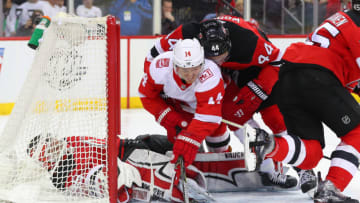 NEWARK, NJ - JANUARY 22: Detroit Red Wings right wing Gustav Nyquist (14) gets pushed over New Jersey Devils goaltender Cory Schneider (35) by New Jersey Devils left wing Miles Wood (44) during the third period of the National Hockey League game between the New Jersey Devils and the Detroit Red Wings on January 22, 2018, at the Prudential Center in Newark, NJ. (Photo by Rich Graessle/Icon Sportswire via Getty Images)