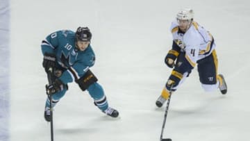 Apr 5, 2014; San Jose, CA, USA; San Jose Sharks center Andrew Desjardins (10) skates with the puck as Nashville Predators defenseman Ryan Ellis (4) defends during the first period at SAP Center at San Jose. Mandatory Credit: Ed Szczepanski-USA TODAY Sports