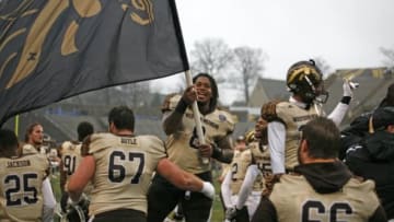 Nov 27, 2015; Toledo, OH, USA; Western Michigan Broncos defensive lineman Cleveland Smith (8) waves their flag after the game against the Toledo Rockets at Glass Bowl. Broncos win 35-30. Mandatory Credit: Raj Mehta-USA TODAY Sports