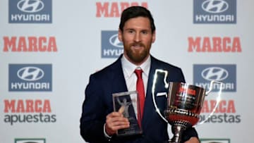TOPSHOT - Barcelona's Argentinian forward Lionel Messi poses after receiving the Alfredo Diestefano award and the 'Pichichi' award for the 2016-17 leading goalscorer of the Spanish league, in Barcelona on December 18, 2017. / AFP PHOTO / LLUIS GENE (Photo credit should read LLUIS GENE/AFP via Getty Images)