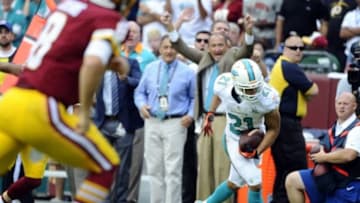 Sep 13, 2015; Landover, MD, USA; Miami Dolphins cornerback Brent Grimes (21) runs after intercepting a pass against the Washington Redskins during the first half at FedEx Field. Mandatory Credit: Brad Mills-USA TODAY Sports