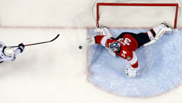 SUNRISE, FL - DECEMBER 1: Brayden Point #21 of the Tampa Bay Lightning scores in overtime for the win against Goaltender James Reimer #34 of the Florida Panthers at the BB&T Center on December 1, 2018 in Sunrise, Florida. (Photo by Eliot J. Schechter/NHLI via Getty Images)