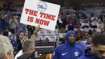 PHILADELPHIA, PA - OCTOBER 20: Joel Embiid #21 of the Philadelphia 76ers walks onto the court as a fan holds up a sign prior to the game against the Boston Celtics at the Wells Fargo Center on October 20, 2017 in Philadelphia, Pennsylvania. NOTE TO USER: User expressly acknowledges and agrees that, by downloading and or using this photograph, User is consenting to the terms and conditions of the Getty Images License Agreement. (Photo by Mitchell Leff/Getty Images)