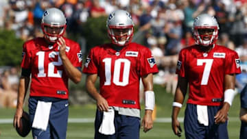 Jul 28, 2016; Foxboro, MA, USA; New England Patriots quarterback Tom Brady (12), quarterback Jimmy Garoppolo (10) and quarterback Jacoby Brissett (7) during training camp at Gillette Stadium. Mandatory Credit: Winslow Townson-USA TODAY Sports