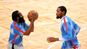 NEW YORK, NEW YORK - JANUARY 16: James Harden #13 of the Brooklyn Nets shoots as Kevin Durant #7 runs past during warmups before the first half against the Orlando Magic at Barclays Center on January 16, 2021 in the Brooklyn borough of New York City. NOTE TO USER: User expressly acknowledges and agrees that, by downloading and or using this Photograph, user is consenting to the terms and conditions of the Getty Images License Agreement. (Photo by Sarah Stier/Getty Images)