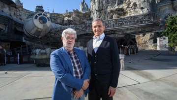 ANAHEIM, CA - MAY 29: In this handout photo provided by Disneyland Resort, Walt Disney Company Chairman and CEO Bob Iger (R), and Star Wars creator George Lucas stand in front of the Millennium Falcon at Star Wars: Galaxy's Edge at Disneyland Park in Anaheim, California, May 29, 2019.  (Photo by Richard Harbaugh/ Disneyland Resort via Getty Images)