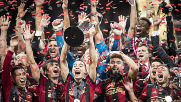 ATLANTA, GA - DECEMBER 08: Miguel Almiron #10 of Atlanta United raises the Phillip P. Anschutz MLS Championship Trophy in celebration with other teammates after the 2018 Audi MLS Cup Championship match between Atlanta United and the Portland Timbers at the Mercedes Benz Stadium on December 08, 2018 in Atlanta, GA. Atlanta United won the match with a score of 2 to 0. (Photo by Ira L. Black/Corbis via Getty Images)