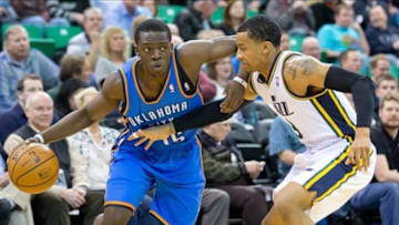 Jan 7, 2014; Salt Lake City, UT, USA; Oklahoma City Thunder point guard Reggie Jackson (15) drives against Utah Jazz point guard Trey Burke (3) during the first quarter at EnergySolutions Arena. Mandatory Credit: Russ Isabella-USA TODAY Sports