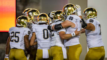 BLACKSBURG, VA - OCTOBER 09: Notre Dame Fighting Irish players celebrate after a touchdown against the Virginia Tech Hokies during the first half of the game at Lane Stadium on October 9, 2021 in Blacksburg, Virginia. (Photo by Scott Taetsch/Getty Images)