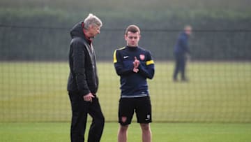 ST ALBANS, ENGLAND - FEBRUARY 18: Arsenal manager Arsene Wenger talks to Jack Wilshere during a training session ahead of their UEFA Champions League round of 16 first leg match against FC Bayern Muenchen at London Colney on February 18, 2013 in St Albans, England. (Photo by Shaun Botterill/Getty Images)