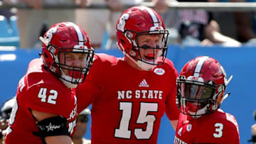 CHARLOTTE, NC - SEPTEMBER 02: Teammates Dylan Autenrieth #42, Ryan Finley #15 and Kelvin Harmon #3 of the North Carolina State Wolfpack react after a touchdown against the South Carolina Gamecocks during their game at Bank of America Stadium on September 2, 2017 in Charlotte, North Carolina. (Photo by Streeter Lecka/Getty Images)