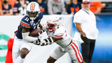 Auburn football wide receiver Shedrick Jackson (11) tries to brea free from Houston safety Gervarrius Owens (32) during the Birmingham Bowl at Protective Stadium in Birmingham, Ala., on Tuesday December 28, 2021.Bham39