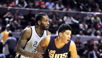 MEXICO CITY, MEXICO - JANUARY 14: Devin Booker #1 of the Phoenix Suns boxes out against Kawhi Leonard #2 of the San Antonio Spurs as part of NBA Global Games at Arena Ciudad de Mexico on January 14, 2017 in Mexico City, Mexico. NOTE TO USER: User expressly acknowledges and agrees that, by downloading and or using this Photograph, user is consenting to the terms and conditions of the Getty Images License Agreement. Mandatory Copyright Notice: Copyright 2017 NBAE (Photo by Barry Gossage/NBAE via Getty Images)