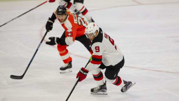 PHILADELPHIA, PA - OCTOBER 09: Taylor Hall #9 of the New Jersey Devils controls the puck against Oskar Lindblom #23 of the Philadelphia Flyers at the Wells Fargo Center on October 9, 2019 in Philadelphia, Pennsylvania. The Flyers defeated the Devils 4-0. (Photo by Mitchell Leff/Getty Images)